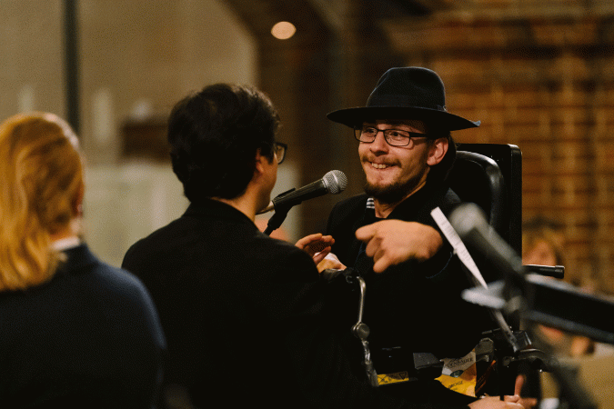 Mann mit körperlicher Behinderung im Rollstuhl, MItglied des Utopia Orchester
