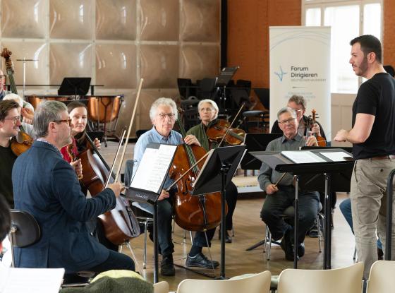 Dirigent Orr Guy im Austausch mit Prof. Lothar Strauß vom Kritischen Orchester